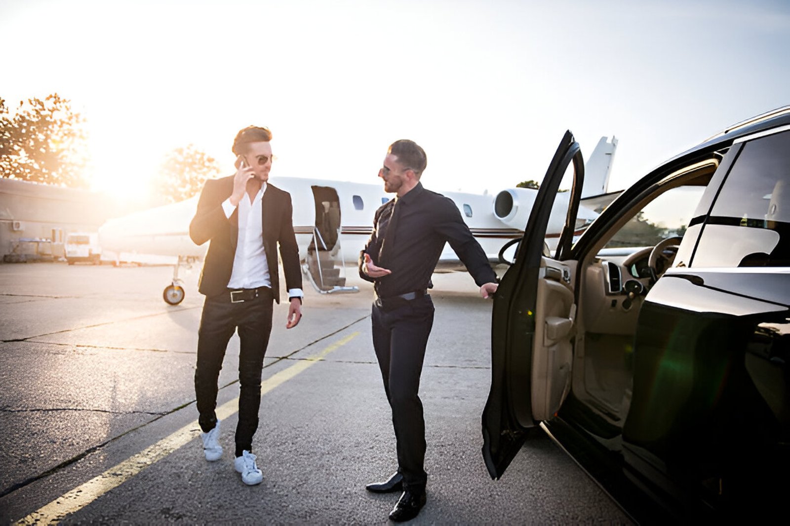 a businessman is heading towards black car at airport