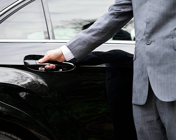 Closeup of a doormans opening a car door. - limo service springfield il